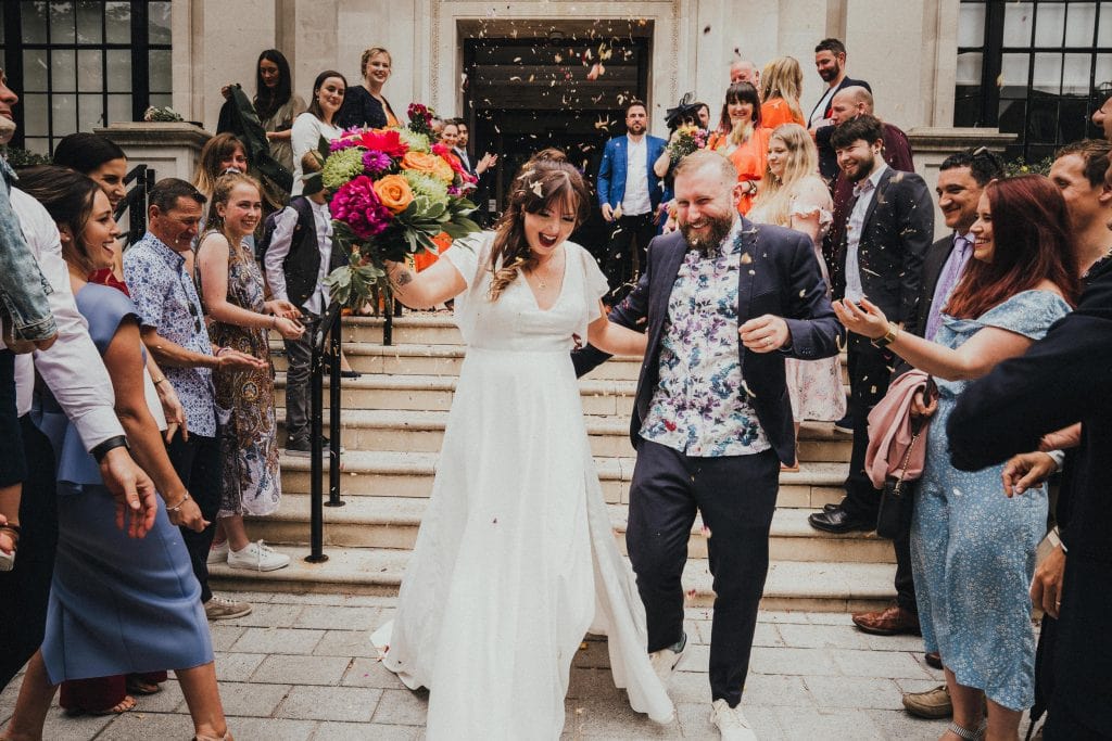 A Colourful and Relaxed London City Wedding with confetti thrown at a bride and groom.