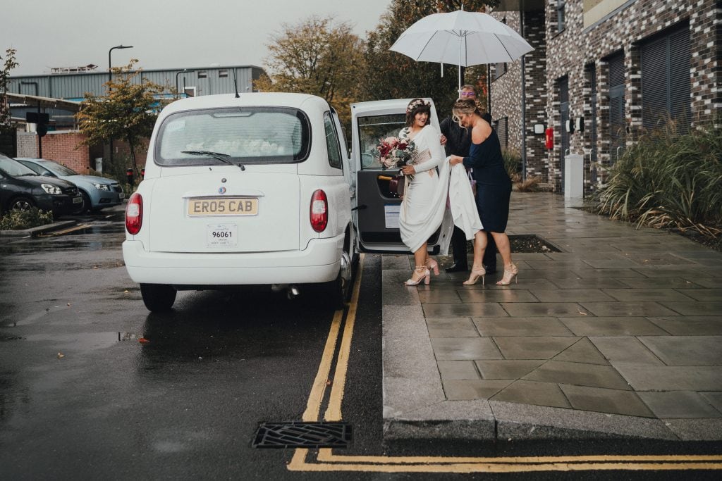 Bride getting in taxi