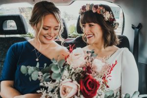 Bride and bridesmaid in taxi