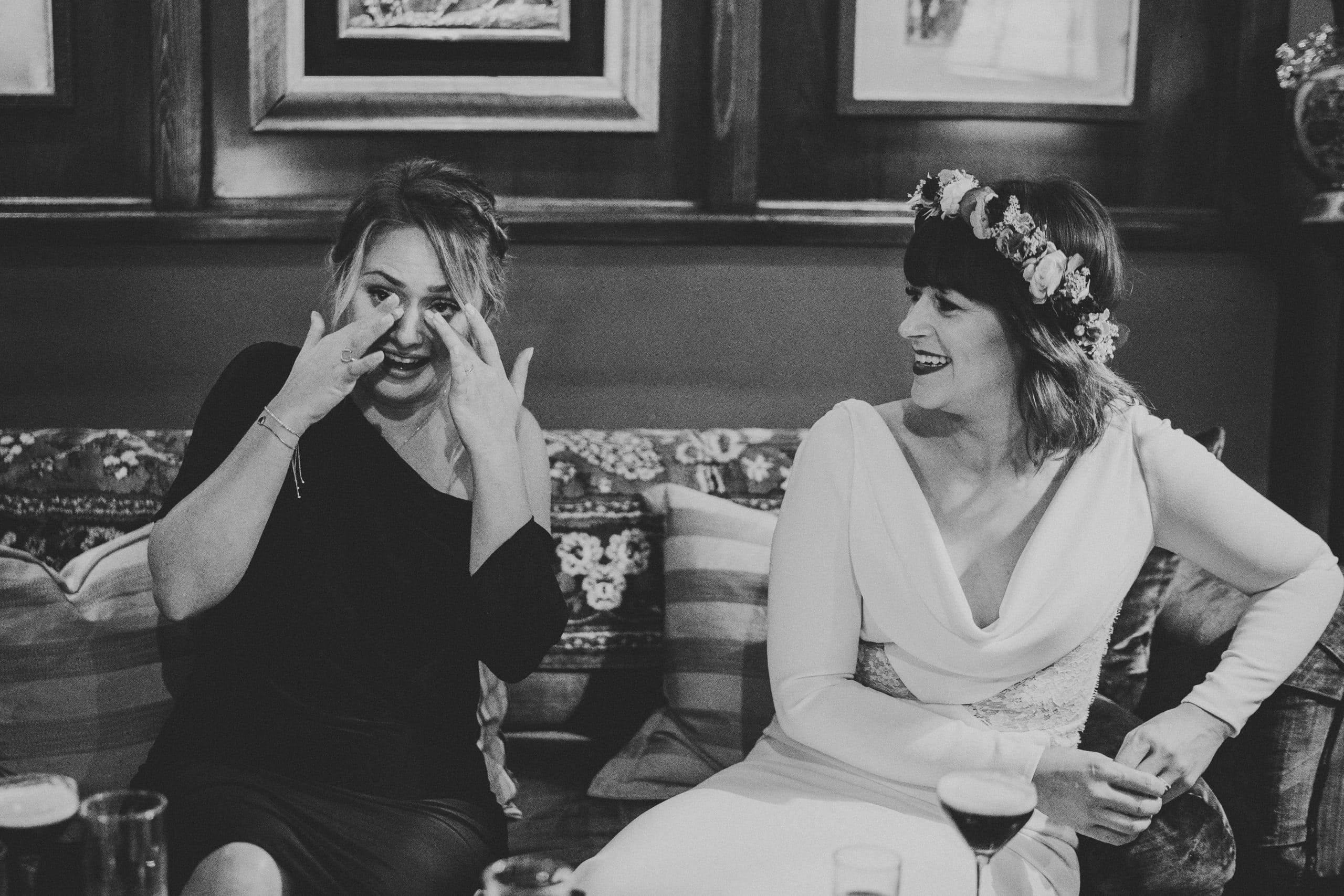 Two women laughing during an Old Marylebone Town Hall wedding.
