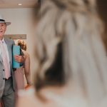 father of the bride sees her in her dress for the first time