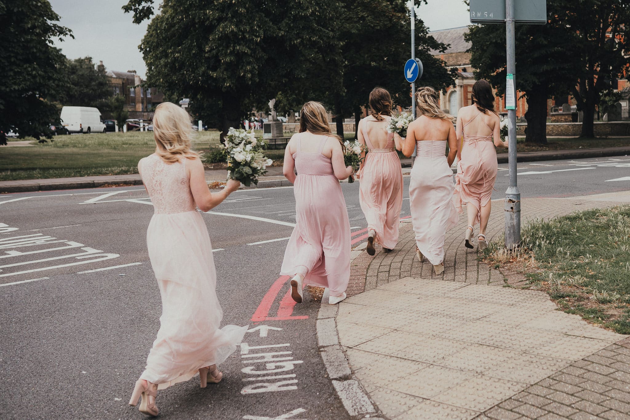 bridesmaids preparing to cross street