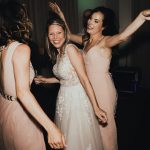 bride dancing with her bridesmaids