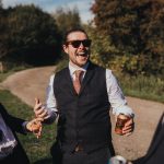 best man telling a joke and laughing