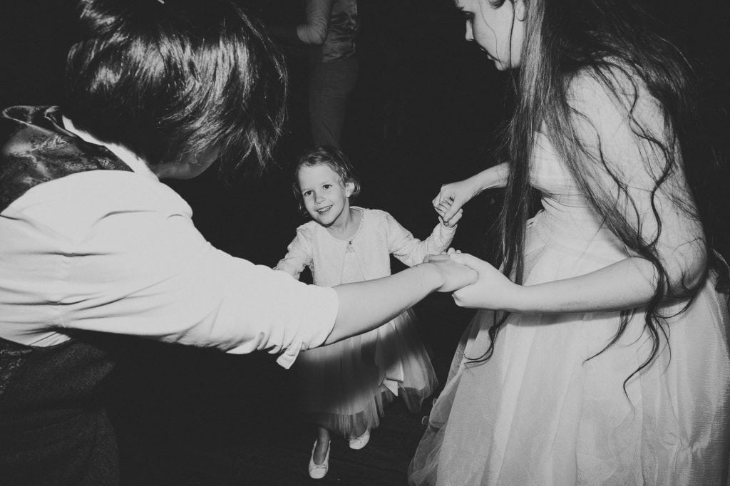 brides dancing with flower girl