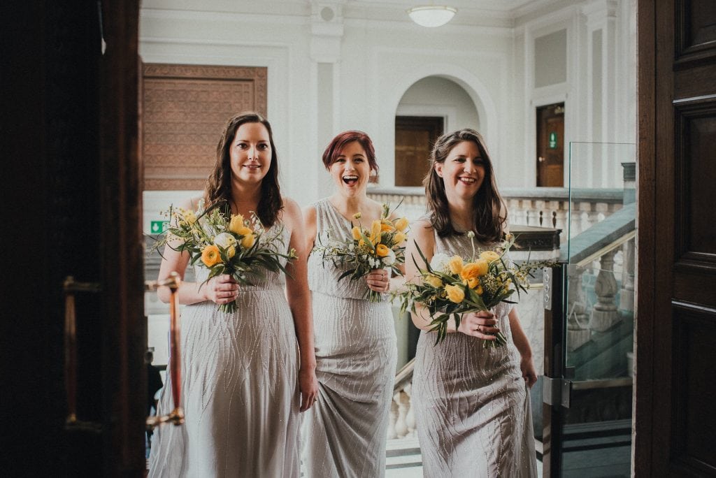 bridesmaids walk into islington town hall