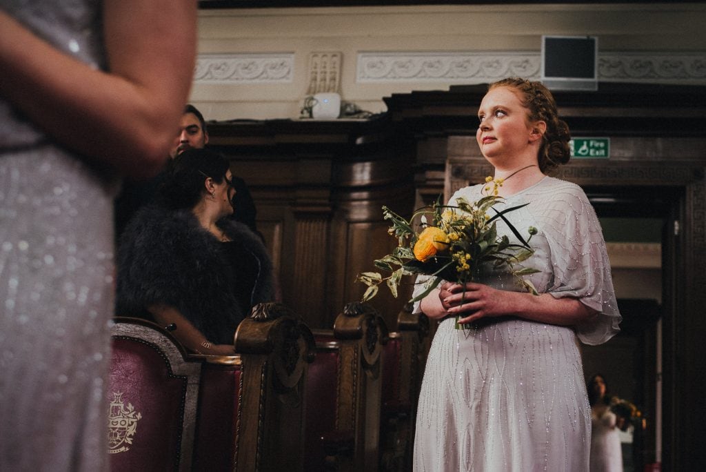 bridesmaid pulls funny face walking into ceremony