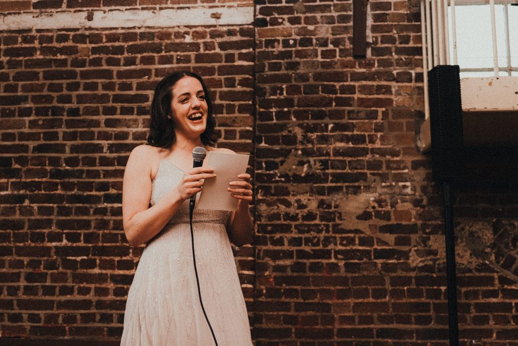 bridesmaid laughing during her speech