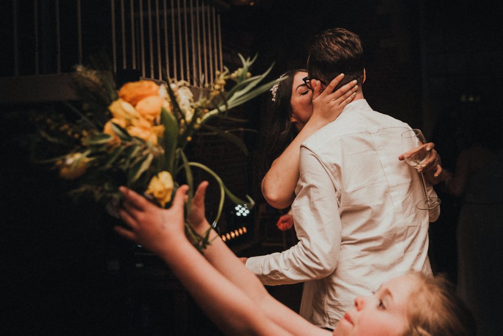 bride kisses groom on dancefloor