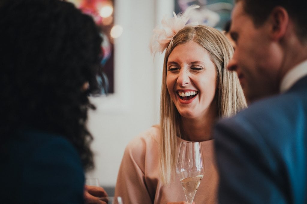a wedding guest laughing at a joke