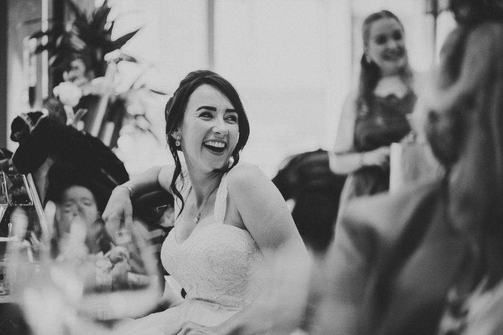 the bride laughing at her dad's speech