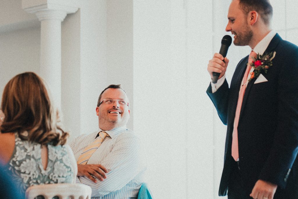 guest looking at groom during speech