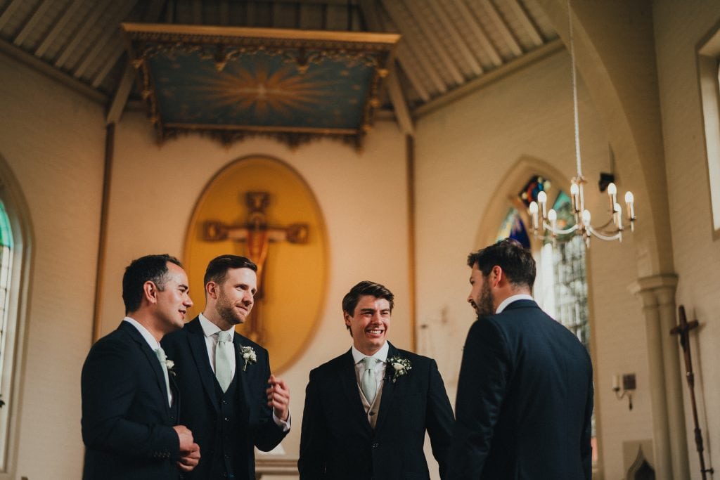 groom laughing with ushers