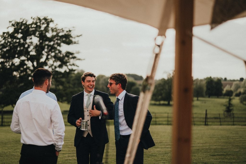 groom laughing with friends