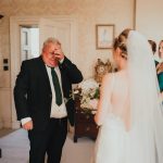 the father of the bride crying seeing her in her dress