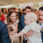guest interacting with a baby during the wedding