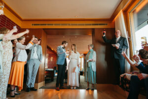 Wedding toast celebration with smiling guests indoors