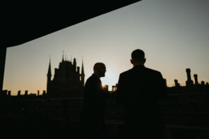 Silhouettes at sunset with city skyline