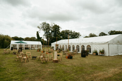 Outdoor marquee for event with garden seating.
