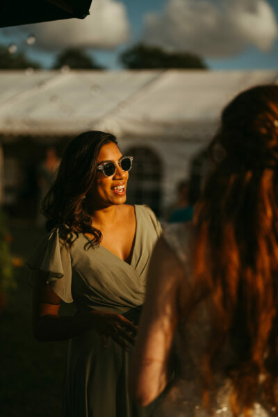 Woman in sunglasses at outdoor event.
