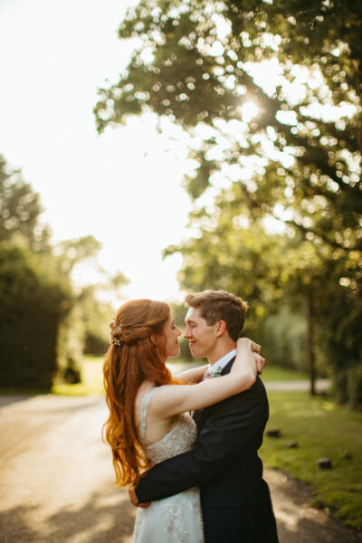 Couple embracing in sunny park setting