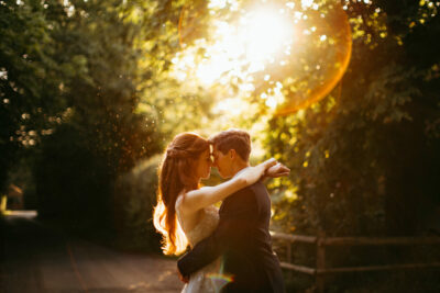 Couple embracing at sunset in forest.