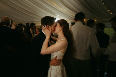 Couple sharing intimate dance at wedding reception.