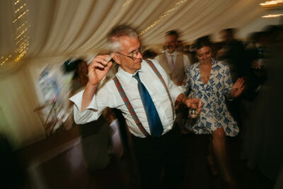 Man dancing at wedding reception party.