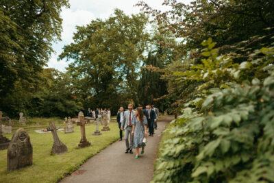 People walking in a cemetery park.