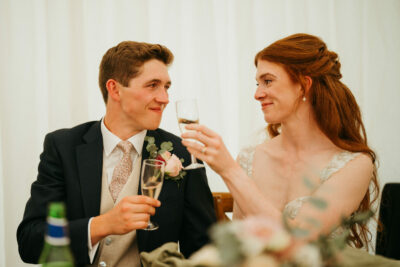 Couple toasting at wedding reception.