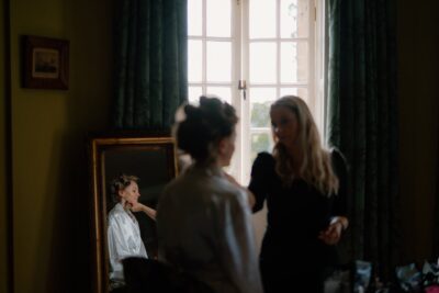 Woman getting ready in front of mirror