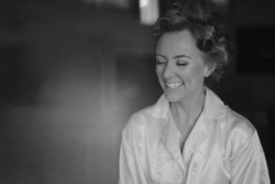 Woman smiling in black and white photo.