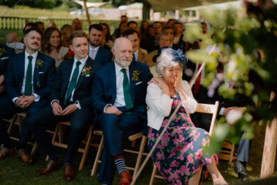 Audience seated at an outdoor wedding ceremony.