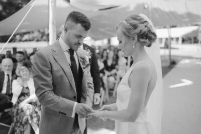 Bride and groom exchanging rings at ceremony.