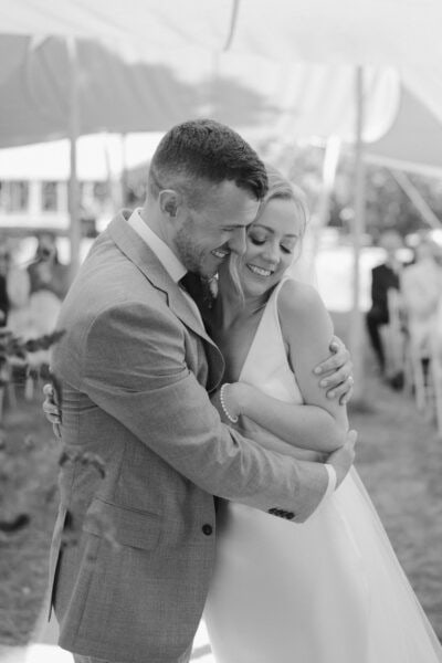 Bride and groom embracing joyfully at wedding