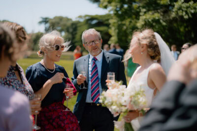 Guests enjoying conversation at outdoor wedding reception