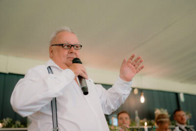 Man speaking into microphone at event.