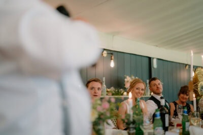 Wedding guests listening during reception speech.