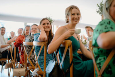 Guests smiling at a wedding reception.