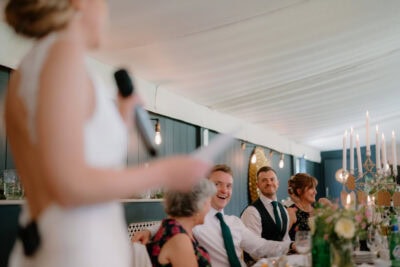 Wedding speech at decorated reception table.