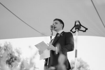 Man giving speech outdoors at event.