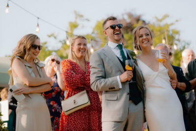 Outdoor wedding celebration with joyful guests.