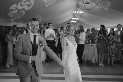 Wedding couple dancing with guests watching