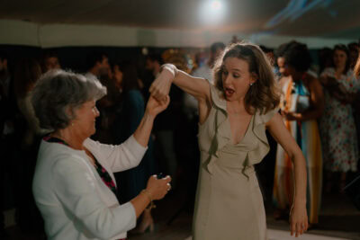 Two women dancing at a party.