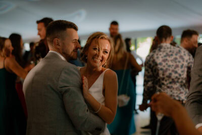 Couple dancing joyfully at a wedding reception.