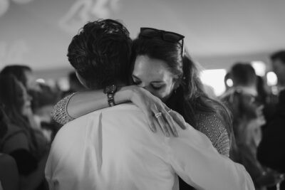 Couple hugging at a lively party scene