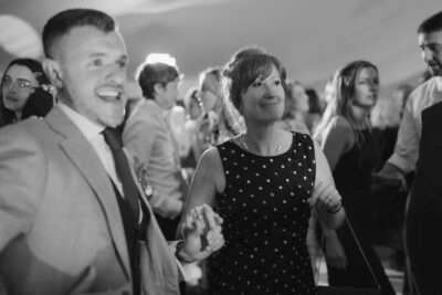 Smiling people dancing at a joyful celebration.