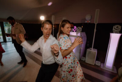 Couple dancing enthusiastically at a party.