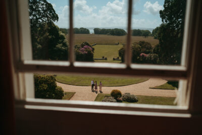 View of garden and people through windowpane