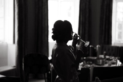 Woman sipping wine in elegant silhouette
